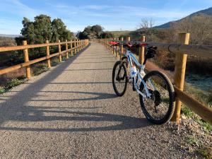 a bike parked next to a fence on a road at Las Musas, Casa Rural in Hervás
