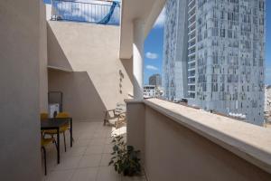 a balcony with a view of a tall building at 2BD and 2 Bath duplex on the Hilton beach with a shelter in Tel Aviv