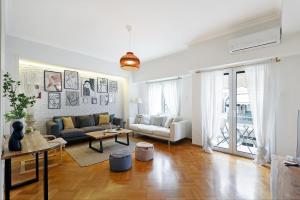 a living room with a couch and a table at Central Kolonaki flat B - Greecing in Athens