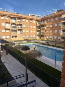 a swimming pool in front of a building at Balcón de la Torre del Morche en Torrox Costa in El Morche