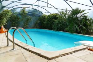 a swimming pool in a domed building with at La maison d'art et d'hôtes in Leuglay