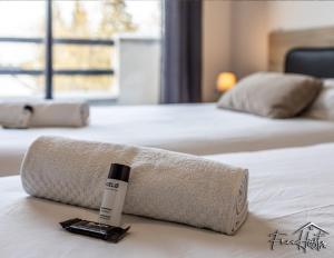 a roll of towels on top of a bed at Magny's Oasis - DisneyLand 5min - Private Parking - Terrace & Garden in Magny-le-Hongre