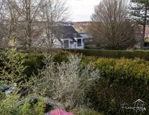 a view of a yard with a house and trees at Magny's Oasis - DisneyLand 5min - Private Parking - Terrace & Garden in Magny-le-Hongre