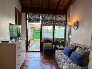 a living room with a couch and a television at Casa Rio Cubas in Cubas