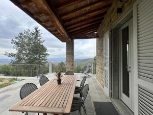 a wooden table and chairs on a porch at Villa Luana in Cortona