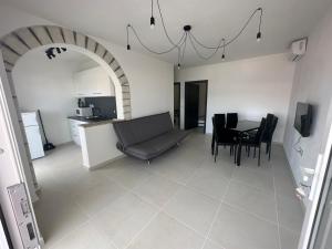 a living room and dining room with a table and chairs at Villa Melissa in Pag