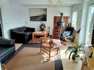 a living room with chairs and a table and a couch at Oestermark in Ærøskøbing