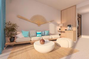 a living room with a couch and a table at Ventale Island Breeze Resort in Kavros