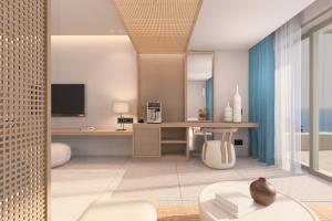 a living room with a desk and a tv at Ventale Island Breeze Resort in Kavros