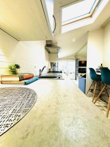 a kitchen with a long counter in a room at Ocean Breeze in Filey