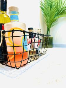 a wire basket filled with bottles of liquid on a counter at Ocean Breeze in Filey