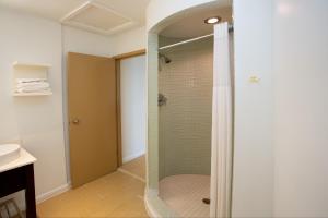 a shower with a glass door in a bathroom at Aqua Vista Resort Hotel in Virginia Beach