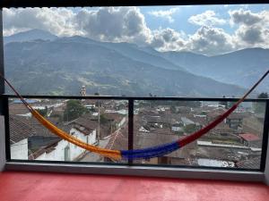 a view from a balcony with a hammock at GLL HOTEL in El Cocuy
