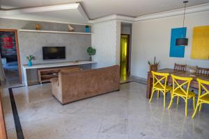 a living room with a couch and a table and chairs at Linda casa com piscina em Interlagos Vila Velha ES in Vila Velha