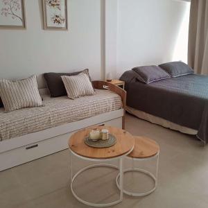 a living room with a couch and a coffee table at LA VIZNAGA in Concepción del Uruguay +2 photos