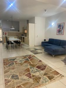 a living room with a blue couch and a table at Sliema 2bed with Backyard in Sliema