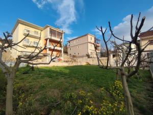 two buildings in a yard with a green field at Sunset View in Ioannina