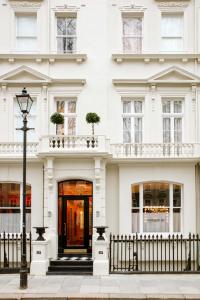 a white building with a door and a street light at Grand Hotel Bellevue London in London