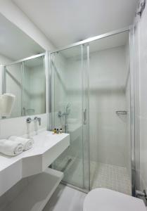 a bathroom with a glass shower and a toilet at UK HOTEL İSTANBUL in Istanbul