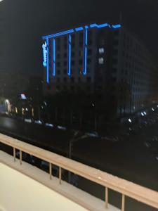 a building with blue lights on it at night at شقه للايجار مكرم عبيد 1 in Cairo