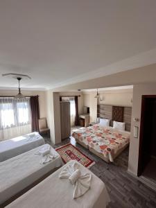 a hotel room with two beds in a room at Akay Hotel in Selcuk