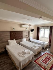 a hotel room with two beds in a room at Akay Hotel in Selcuk