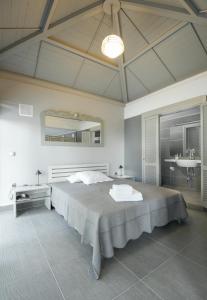 - une chambre avec un grand lit et un lavabo dans l'établissement Recon Luxury Living Paliouri, à Paliouri