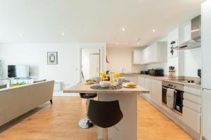 a kitchen with a large island in the middle at Leeds City Centre 2 Bed 2 Bath in Leeds