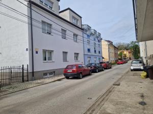 a row of cars parked on a street with buildings at "Apartment Lavanda Idila", speed WiFi in Zagreb