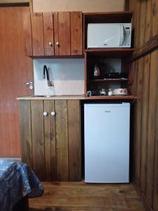 賓海洛的住宿－Recanto Cabanas，厨房配有白色冰箱和微波炉