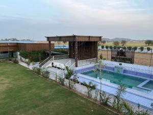 an overhead view of a swimming pool at a resort at Zoravar Farms in Sohna