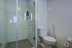 a bathroom with a toilet and a glass shower at Rio hotel by Bourbon Indaiatuba Viracopos in Indaiatuba