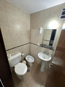 La salle de bains est pourvue de toilettes, d'un bidet et d'un lavabo. dans l'établissement Hotel Quito, à Buenos Aires