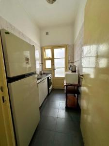 a kitchen with a white refrigerator and a sink at DPTO 3 AMB in Mar del Plata