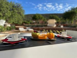 a black tray with a plate of fruit on a table at Boutique Bed And Breakfast - Casa Esteval in Rocha Amarela