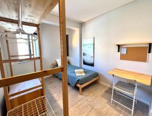 a small room with a bunk bed and a desk at Campus 121 - Rooms in Faro