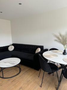 a living room with two tables and a couch at Sea Oasis apartment in Liepāja