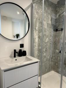 a bathroom with a sink and a shower at Sea Oasis apartment in Liepāja