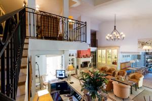 a large living room with a staircase and a living room at La Bastide de Valbonne in Valbonne