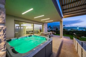 a hot tub on the patio of a house at Diamond Dream 4 in Kalamaki