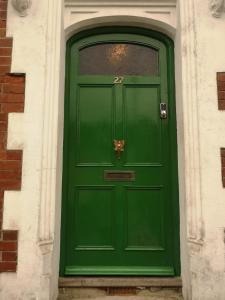 a green door in a building with a window at Freedom Park Villa room 3 in Plymouth