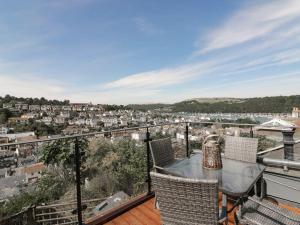 a balcony with a table and chairs overlooking a city at Topsail in Dartmouth