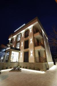 a large building with lights on it at night at Residence Inn Hotel in Tirana