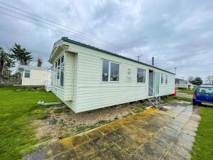 a small white house sitting on top of a yard at Wonderful 8 Berth Caravan At Valley Farm Nearby Clacton-on-sea Ref 46396v in Great Clacton