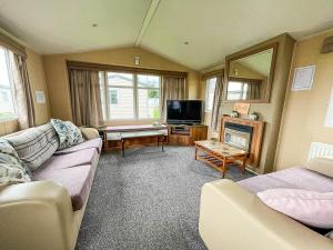 a living room with two couches and a television at Wonderful 8 Berth Caravan At Valley Farm Nearby Clacton-on-sea Ref 46396v in Great Clacton