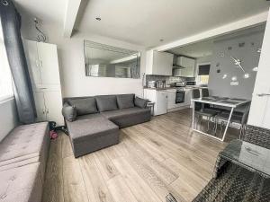 a living room with a couch and a kitchen at Beautiful Chalet In The Seaside Village Of Scratby, Norfolk Ref 51054s in Great Yarmouth