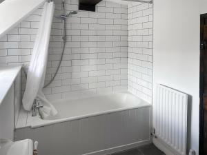a white bath tub in a bathroom with a shower at Ashford Old Farm in Ilton