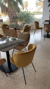 una fila di tavoli e sedie in una stanza di Hotel Golden a Rimini