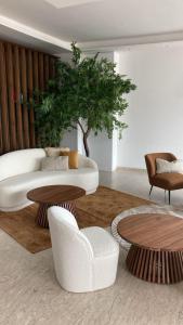 a living room with a white couch and tables at Hotel Golden in Rimini