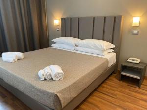 a bedroom with a bed with towels on it at Hotel Golden in Rimini